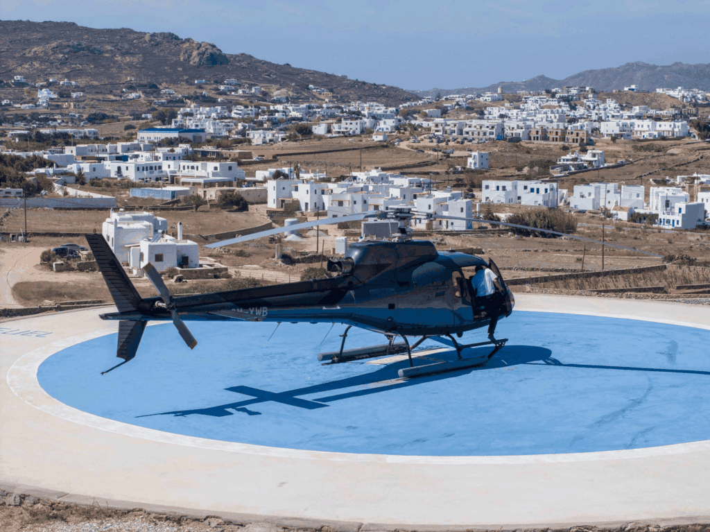 Paros helipad with private helicopter and sea view
