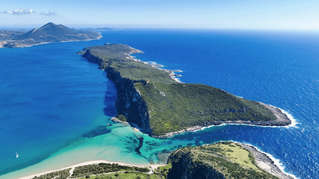 Expansive aerial view of the lush, green Messinian coastline and the luxurious Costa Navarino resort complex in the Peloponnese